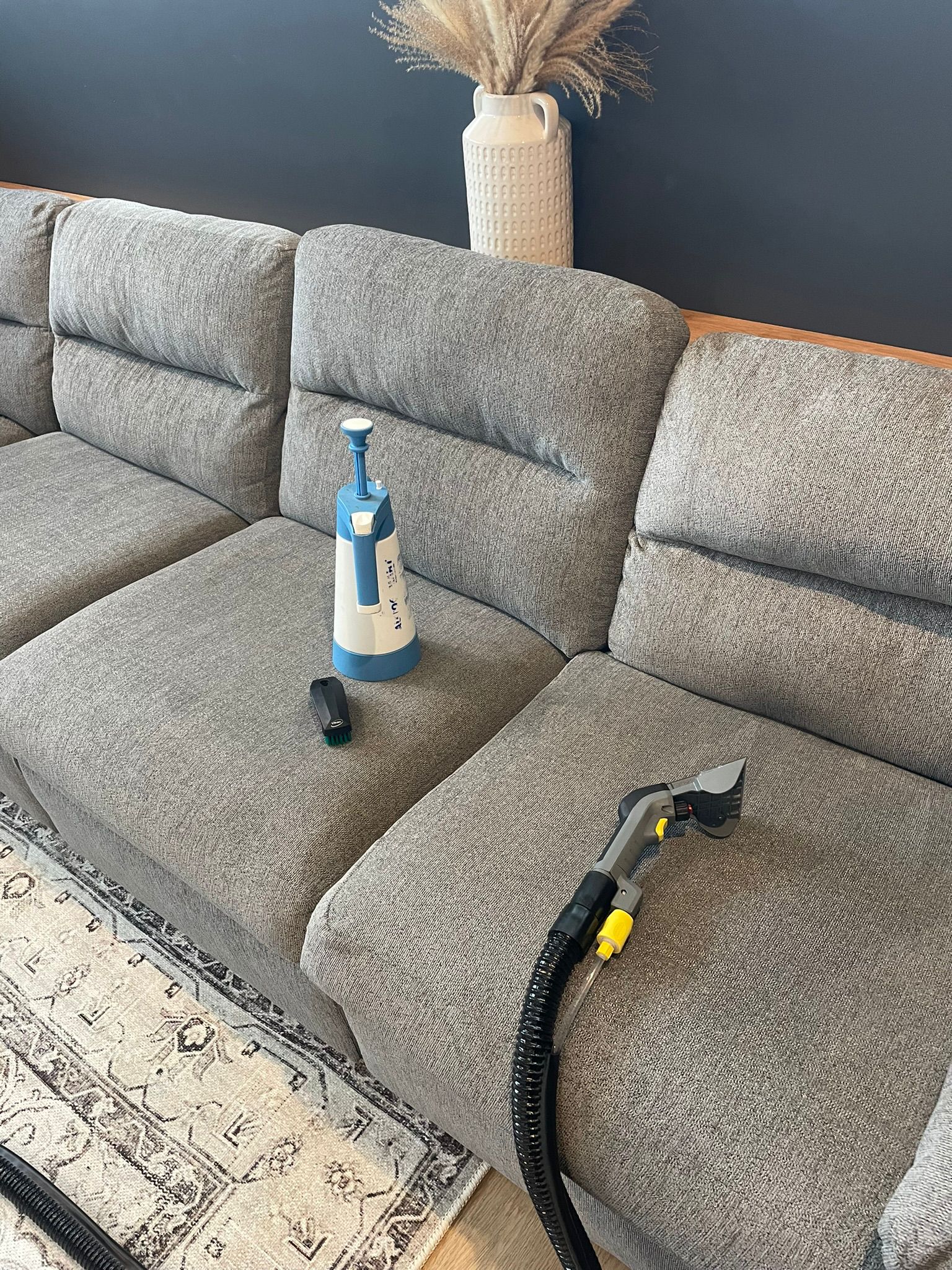 a sofa being steam cleaned